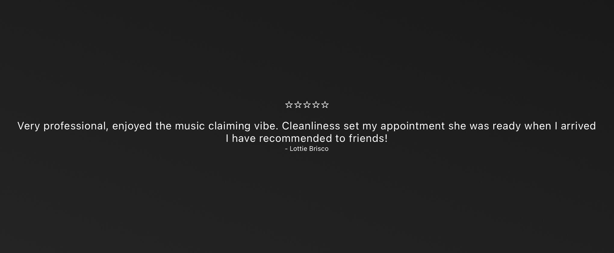 Man with a full beard and neatly twisted braids, captured in warm sunlight while looking downward.