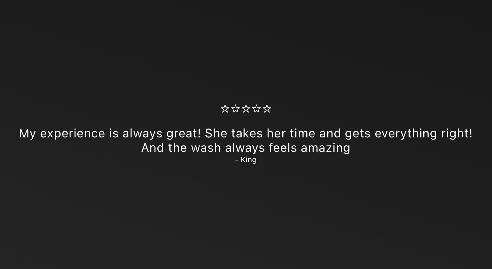 Man with a full beard and neatly twisted braids, captured in warm sunlight while looking downward.