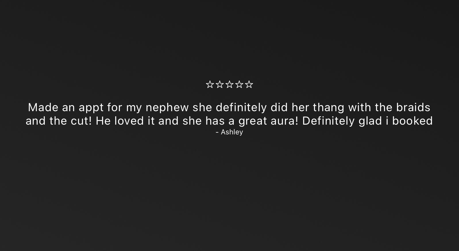 Man with a full beard and neatly twisted braids, captured in warm sunlight while looking downward.